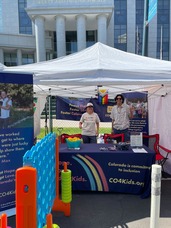 Adrienne Baxter and Yerson Padilla in the Colorado Foster Care Booth at Denver Pride