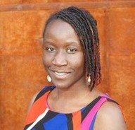 Ndeye Ndao smiles warmly wearing a blue, orange and black top