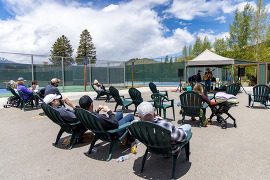 People sitting in chairs listening to music