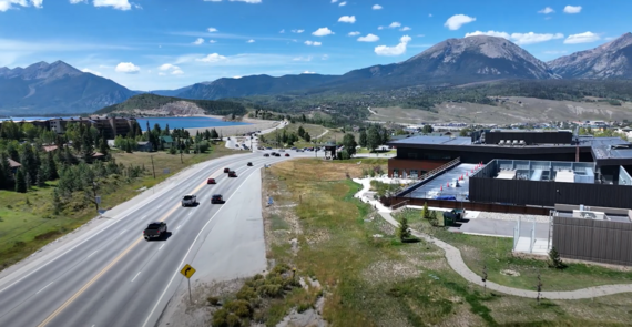 Elevated perspective of mountains and a highway, illustrating the harmonious blend of nature and infrastructure.