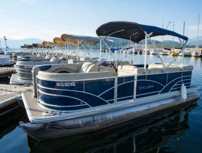 A pontoon boat is securely docked at the marina, ready for its next adventure on the water.