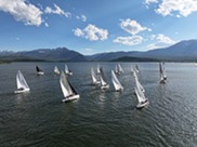 boats sailing against the mountain backdrop
