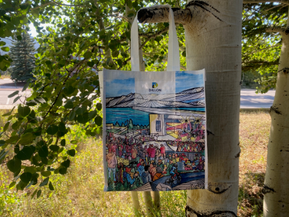 A tote bag adorned with an artistic depiction of individuals interacting in a vibrant scene