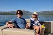 Two people on a boat enjoying a boat ride on a mountain lake 