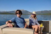 Two people on a boat enjoying a boat ride on a mountain lake 