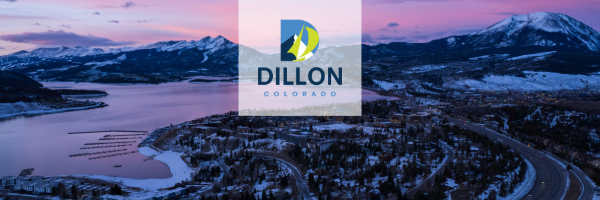 Aerial view of Dillon with the mountains and a soft pink and purple sunrise 