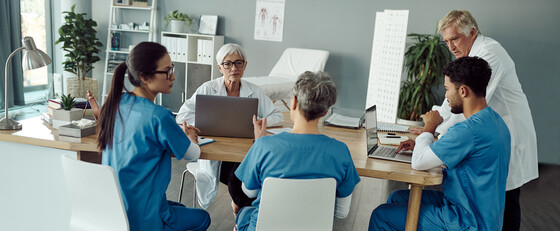 A group of health care providers sitting at a conference table