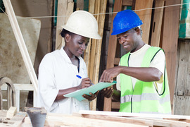 Man and woman in hardhats on a construction site