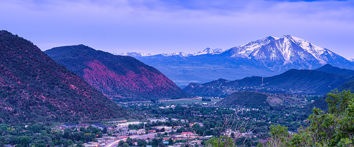 Wide view of Glenwood Springs and mountains at sunset