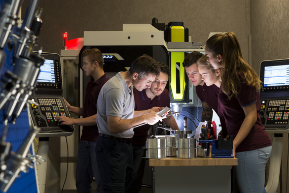Group of people looking over a table in a workspace