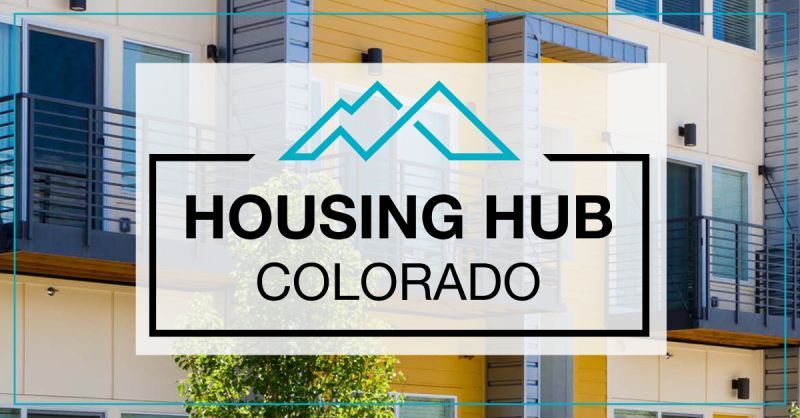 A blue outline of mountains in the top center of a black rectangle surrounding the words Housing Hub Colorado. Apartment balconies in the background.