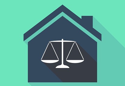 illustrated image of a house outline with a legal scale inside 