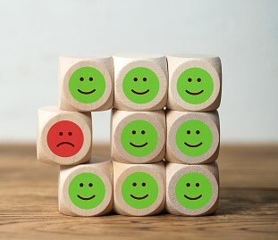 stack of blocks with happy face and one with  sad face