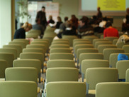 Meeting Room with rows of chairs and people filing in