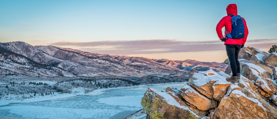 Man hiking on Rocks overlooking Poudre River, in Winter, ft Collins CO