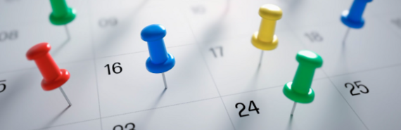 Calendar with push pins on it