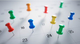 Calendar with push pins on it