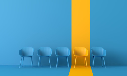 Chairs in waiting area with one highlighted in a yellow vertical stripe