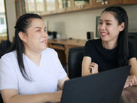 A person with a visual impairment works on their computer. 