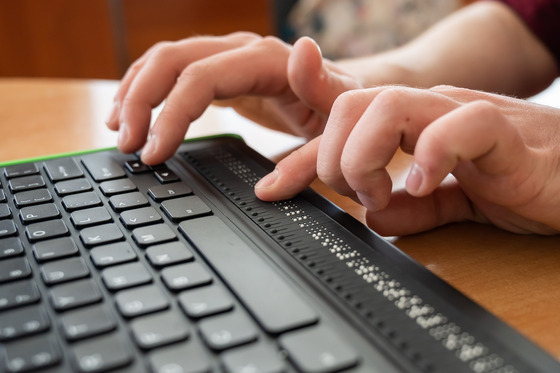 A picture of a keyboard with braille for hearing impaired individuals. 