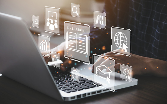 Hands typing on a laptop with digital icons representing e-learning, online courses, and virtual training.
