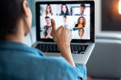 Person sitting at desk with his laptop leading a zoom meeting