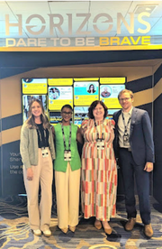Four panelists standing in front of a "Horizons: Dare to Be Brave" sign at the JFF conference.