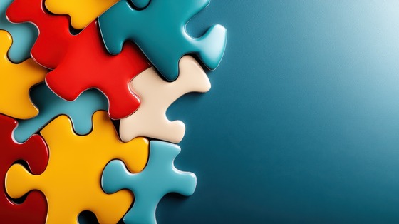 Colorful puzzle pieces fitting together on a blue background, symbolizing connection, collaboration, and problem solving.