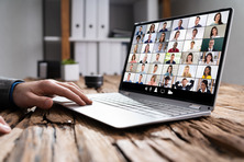 Laptop on a desk with a zoom meeting on the screen 