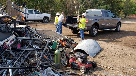 City of Greeley staff unload a truck load into a Spring Clean Up Weekend debris pile.
