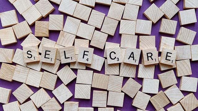 Scrabble tiles spelling out Self Care