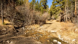 Rebuilt road crossing going through a mountain creek.