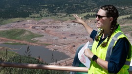 Leah Hubbard gestures toward the construction site of Chimney Hollow Reservoir as she speaks about the water storage project.