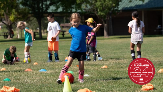 Young girl works on soccer skills in the park