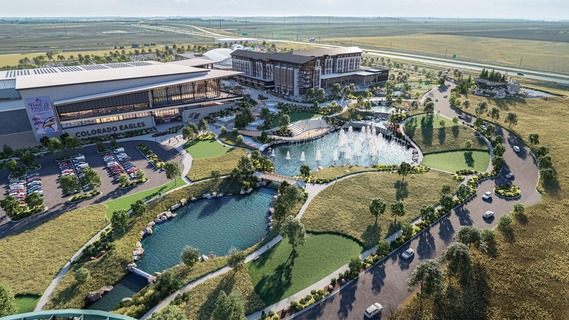 Exterior illustration of an indoor water park, hotel and hockey arena with fountains and parking surrounding the buildings.