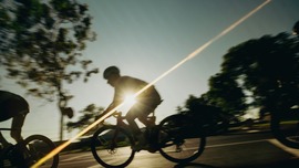Image of bicycle riders and sunset.