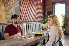 Couple enjoying tacos and drinks together