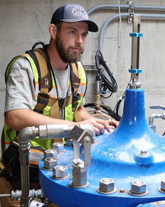 Man conducts preventative maintenance on a valve.