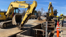 heavy machinery is parked in the street near a water line project