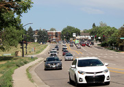 Cars driving down Bowles Ave. with Downtown Littleton in the background