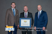 Police Chief Doug Stephens posting with Reaccreditation Award