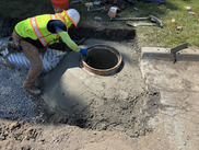 Worker repairing a sewer pipe