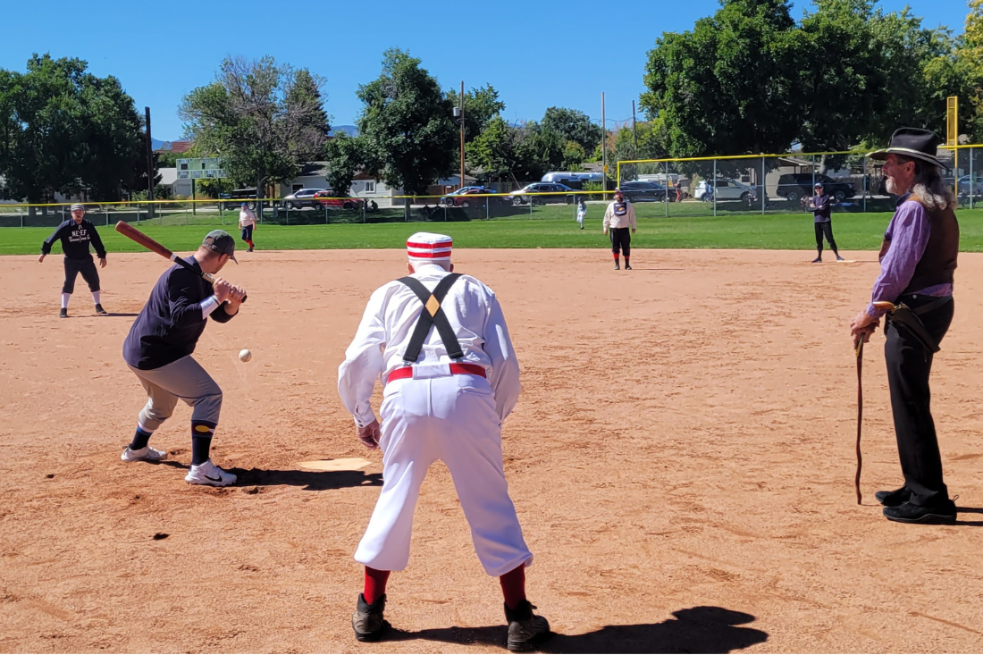 Men play baseball in vintage uniforms