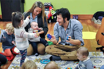 Guy teaching music to little kids