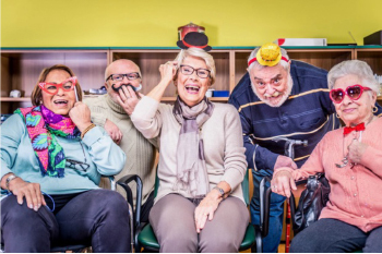group of seniors laughing and wearing funny costumes