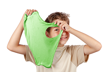 photo of kid holding up green slime