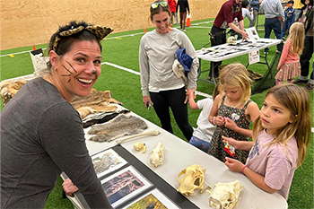 Photo of open space staff educating kids on animal skulls for a Halloween event