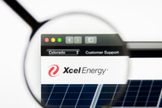 Graphic of Xcel Energy website with a magnifying glass over the Xcel Energy logo