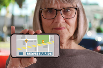 senior woman requesting a ride on a mobile app