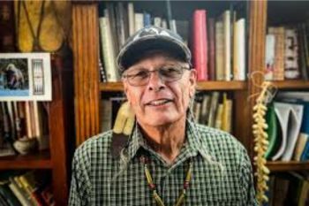 A photo of a man with a feather in his hair